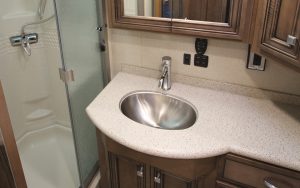 The bath in the Newmar Bay Star 3226 is outfitted with a stainless-steel sink and a glass-fronted shower. 