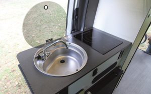 The Winnebago Revel test unit included a stainless-steel sink and a single-burner induction cooktop.