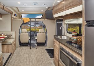 A look inside the 25-foot-long, 96-inch-wide Qwest Type C reveals a light-colored interior, further brightened by high-intensity LED ceiling lights. Easy-to-maintain woven-acrylic flooring and high-gloss, curved European-style cabinetry create a contemporary look. In the 24K, a street-side dinette slideout increases living space. 