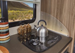 The Qwest’s galley includes this two-burner drop-in stovetop, which comes with a flush cover. The motorhome also is equipped with a 6-cubic-foot three-way refrigerator and a stainless-steel convection-microwave oven. 