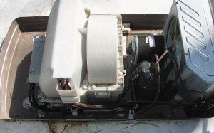 Check the drain holes in the air conditioner pan and remove debris. 