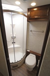 The Renegade Verona 36VBS features a split bath with a fiberglass shower and a macerator toilet on the curb side.
