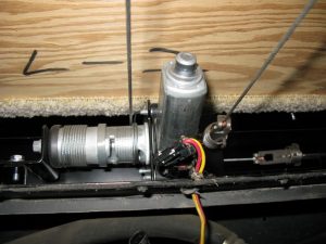 A Winnebago electric step-cover motor usually is hidden from view.