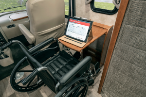 A pull-out table in the cab area of the Adventurer 30T AE accommodates a wheelchair when the adjustable copilot seat is moved forward.