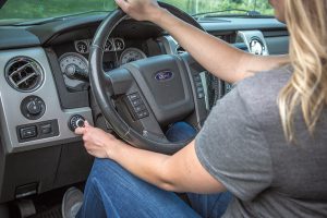 A user operates the Curt Spectrum Trailer Brake Controller (left), which is designed to provide more stable towing. 