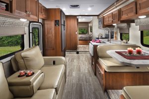 The Forest River Sunseeker 3050S floor plan has a full-wall street-side slideout that contains the midcoach galley and booth-style dinette.