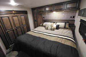 In the bedroom, the head of the 70-inch-by-80-inch king-size bed nestles against the front cap.
