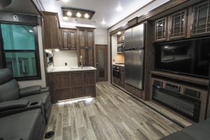 Wood-look vinyl flooring and glazed maple cabinetry and woodwork create a residential atmosphere in the Venom’s living and galley areas. 