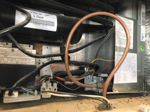 Open the lower exterior compartment occasionally to clean the area.