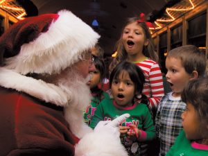 Santa interacts with children on board the Grand Canyon Railway, transformed for the season into the magical Polar Express.