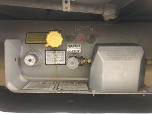 A motorhome’s propane tank is mounted permanently.
