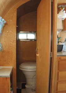 The private bath features a hinged door.