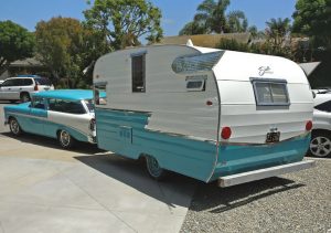 The trailer, now teal and aqua, is towed by a matching 1956 Chevy Nomad station wagon.