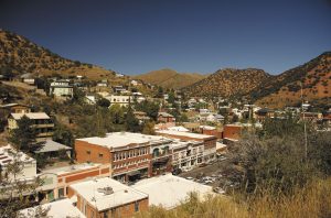 Hillsides in Bisbee rise above the commercial district, which has historical buildings now filled by shops and restaurants.