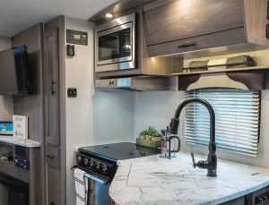 The fully equipped galley has an under-mount sink, complete with a cover and a faucet with a pull-out sprayer.