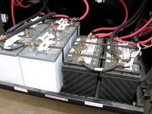 Six-volt house batteries wired in series/parallel are on the left; 12-volt chassis batteries wired in parallel are on the right.