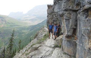 The author's husband and friends stop along a pathway in Glacier National Park, Montana, with soaring views of the Rocky Mountains nearby.