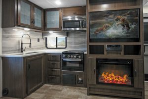 The 2427RB’s nicely equipped galley is next to the entertainment center, which includes a 43-inch LED TV and an electric fireplace.