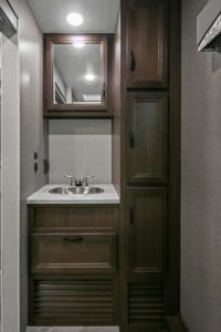 This vanity and linen closet are in the full-width rear bathroom; one of the 2427RB's two entry doors is nearby.