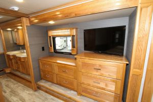 The bedroom contains plentiful drawer storage, along with a 32-inch LED TV.