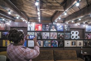 A visitor photographs copies of album covers representing some of the hits produced at Muscle Shoals Sound Studios.
