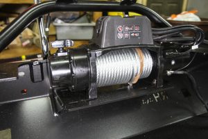 Once a hydraulic jack lifted the steel bumper into position, a Warn Industries winch was mounted to the bumper.