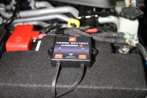 The RVi Towed Battery Charger was mounted to the top of the battery cover.