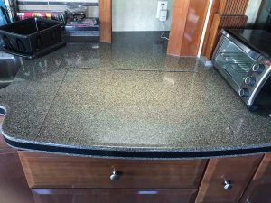 When the stove cover is closed, there is ample workspace on the kitchen counter.