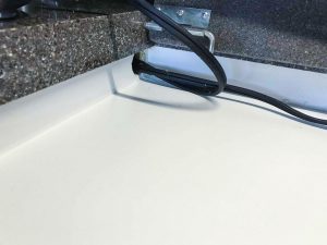 Both induBoth induction cookers' cords are run through a hole in the wall, which is big enough for plugs to pass through should a replacement cooker be needed.ction cookers' cords are run through a hole in the wall, big enough for plugs to pass through should a replacement cooker be needed.