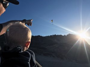 Jesse and Tucker watch a paraglider at Cape Kiwanda.