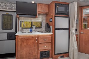 The galley has a two-way refrigerator, a microwave-convection oven, and an LED TV viewable from the slideout.