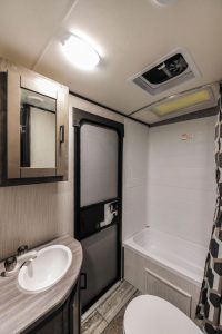 The rear door opens into a full-size residential bath, which includes a shower/bathtub. 