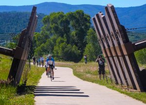 Bicyclists ride along the Yampa River Core Trail.