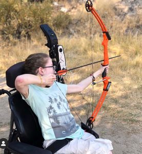 Emily Benson gets an archery lesson.