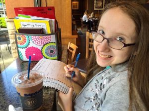 Emily Benson studies in a coffee shop.