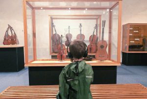 Henry Epperson learns about a Stradivari violin via an audio tour at the National Music Museum in Vermillion, South Dakota.