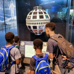 Jayson, Justin, and Keith Jr. Sims at a space exhibit.