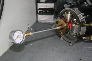 To check fuel pump pressure, remove the burner nozzle and insert a fuel pressure gauge in its place; when the fuel solenoid opens during this test, the gauge should indicate 145 psi.