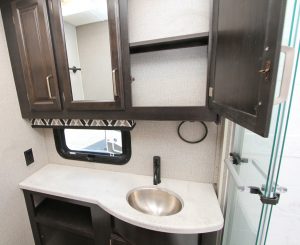 The bath area in the Precept 34G includes a vanity with a stainless-steel sink, plus a sizable medicine cabinet.