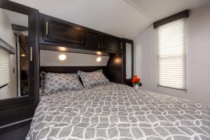 The master bedroom in the front of the Grey Wolf 26DBH includes a queen-size bed and dual wardrobes and nightstands.
