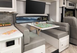 The 32RW’s booth dinette converts for sleeping and is accompanied by a 40-inch TV.