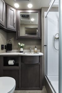 The Miramar 34.6 has a full-size bath with a porcelain toilet, a stainless-steel sink, and a 30-inch-by-36-inch shower.