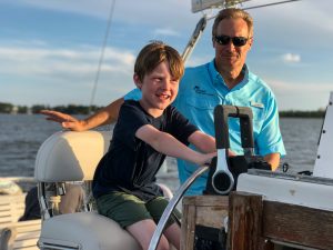 Ethan Epperson takes the helm during the Cetacean Cruises “Sunset and Dolphin Nature Cruise.”