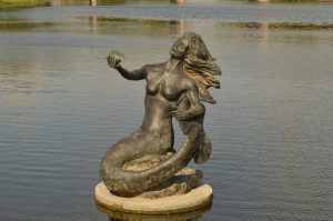 A bronze mermaid statue can be seen along the Concho River Walk in downtown San Angelo.