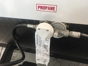 The propane regulator should be checked frequently for debris or damage.