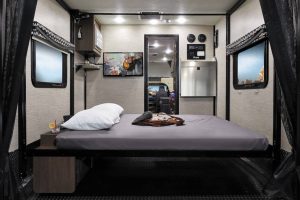 The Thor Motor Coach Outlaw Type C motorhome includes a rear bed that lowers from the ceiling. 