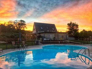 The amenities at Osage Beach RV Park are abundant, including a pool and colorful sunsets.