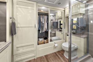 The rear bath includes a closet with mirrored doors and a concealed washer-dryer.