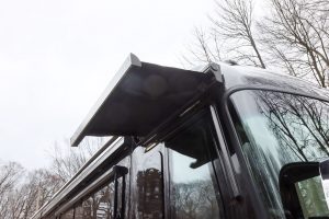 An entry door awning provides cover while unlocking or opening an RV door.