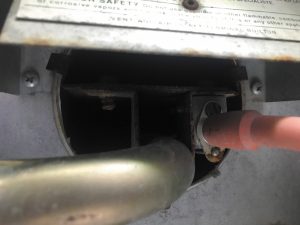 Using compressed or canned air, blow several bursts into the bottom of the heat exchanger tube to clear debris.